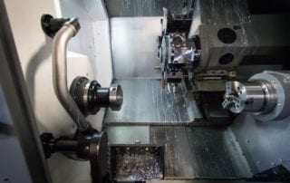 Inside a 6-Axis CNC Turning center with dual spindles and 24-tool turret.